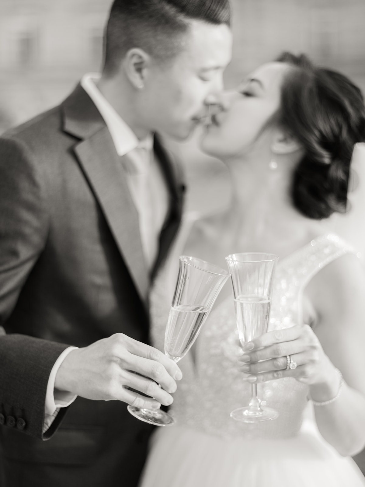 Couple kissing with a glass of champagne in hand